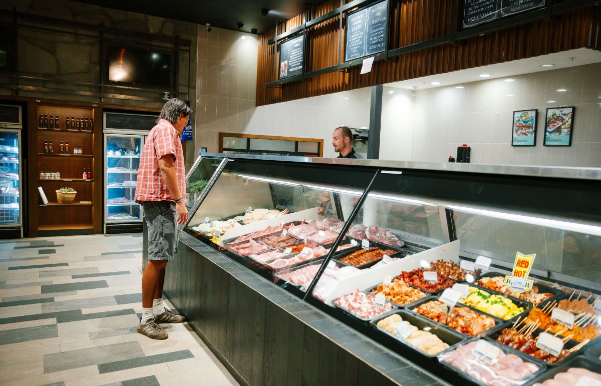 Person standing at Tenderwest Meats looking at meat options